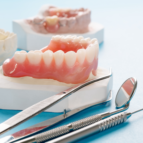 Dentures with dentists tools for denture repair