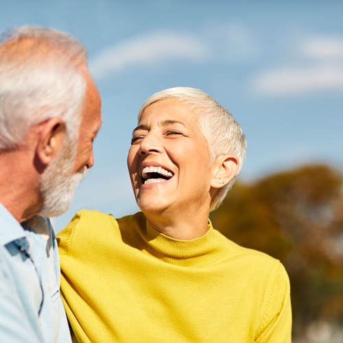 Laughing, happy couple with lady wearing dentures