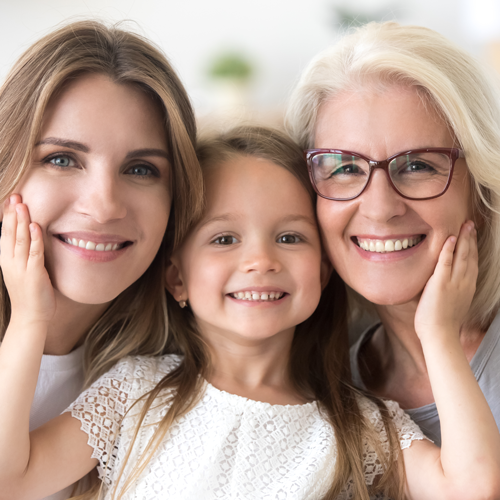 Mother, daughter and grandmother with partial dentures, all smiling with good looking teeth