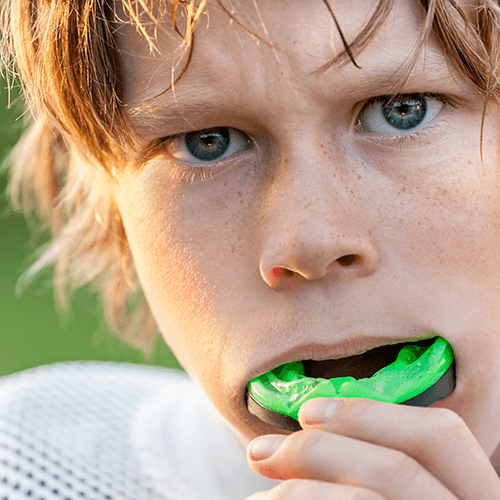 Young boy wearing a custom sports mouthguard